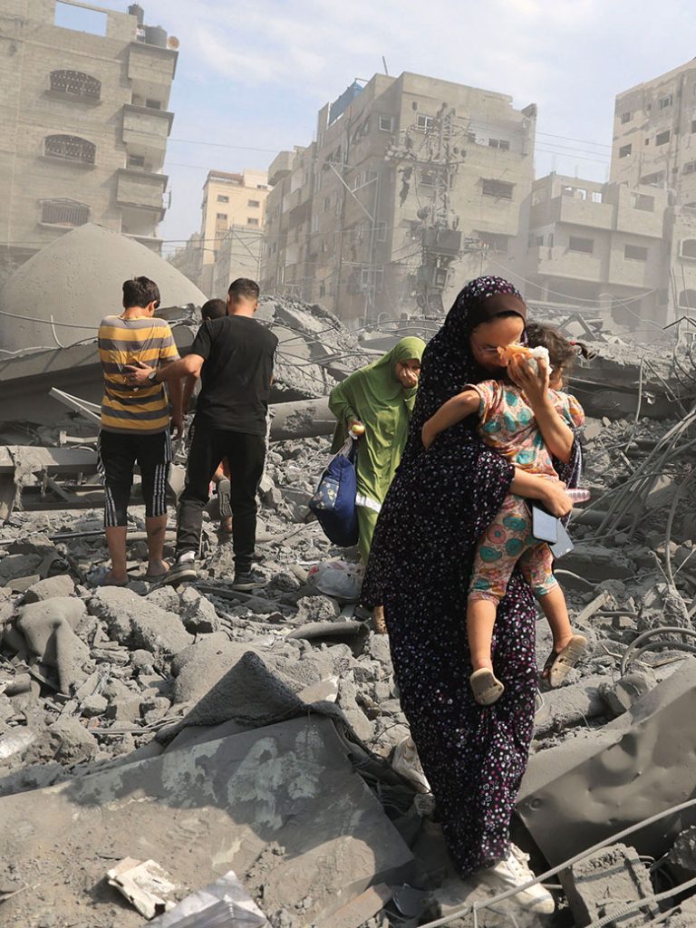 TOPSHOT-PALESTINIAN-ISRAEL-GAZA-CONFLICT TOPSHOT - Palestinians evacuate the area following an Israeli airstrike on the Sousi mosque in Gaza City on October 9, 2023. Israel continued to battle Hamas fighters on October 9 and massed tens of thousands of troops and heavy armour around the Gaza Strip after vowing a massive blow over the Palestinian militants' surprise attack. (Photo by Mahmud HAMS / AFP) (Photo by MAHMUD HAMS/AFP via Getty Images)
